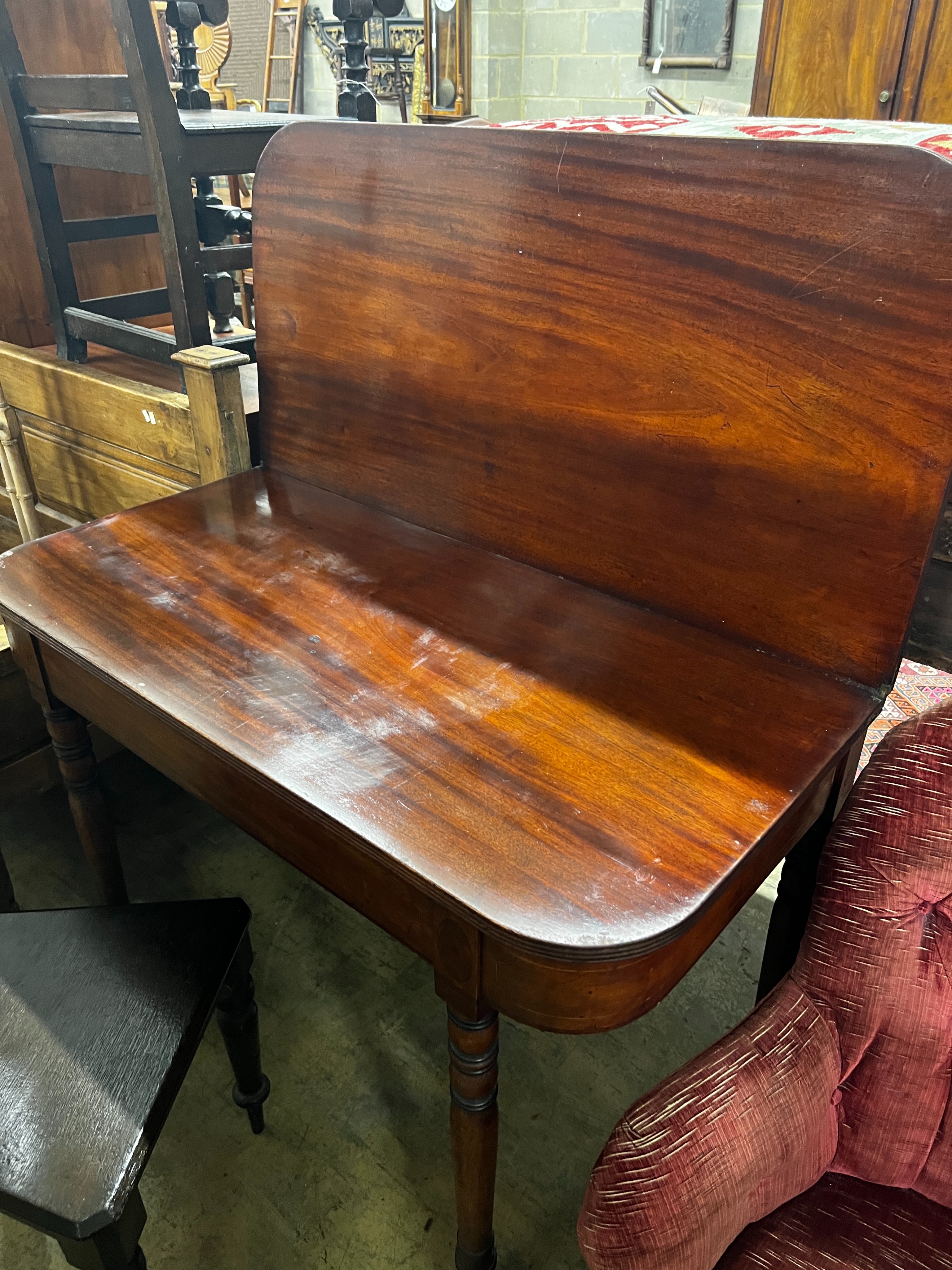 A Regency mahogany folding tea table, width 106cm, depth 52cm, height 77cm and a Victorian oak hall chair